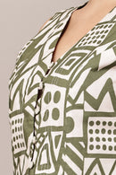 Close-up of a green and white patterned crop top with a neutral background