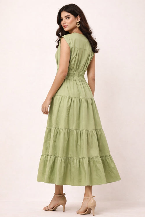 Woman wearing a green maxi dress on a white background