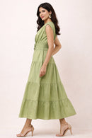 Woman wearing a green maxi dress on a white background
