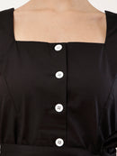 Close-up of a black cotton-like top with a square neckline, front button closure, and white buttons, shown on a model.