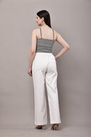 Back view of black and white gingham co-ord set for women with bustier crop top and white wide leg trousers