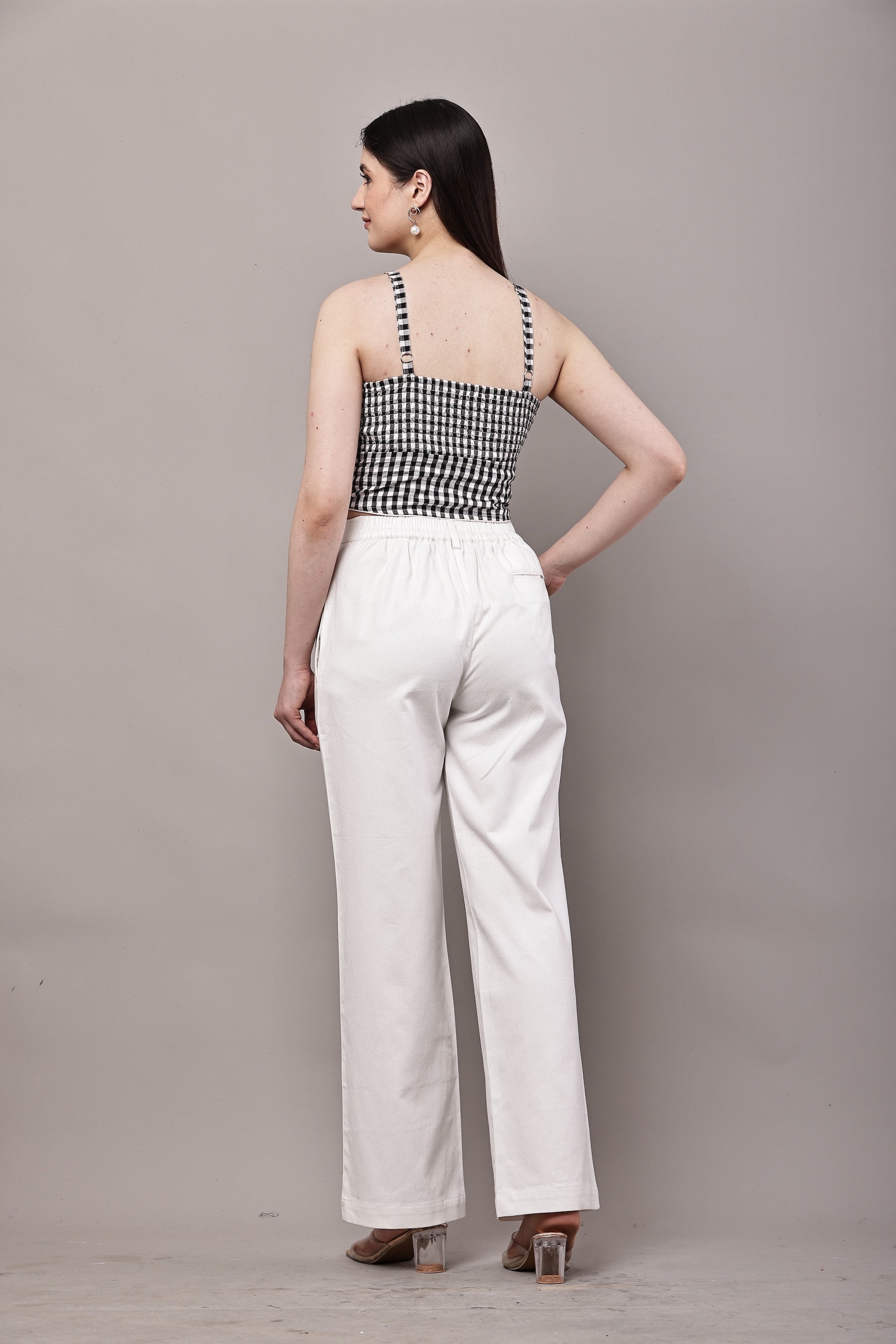 Back view of black and white gingham co-ord set for women with bustier crop top and white wide leg trousers