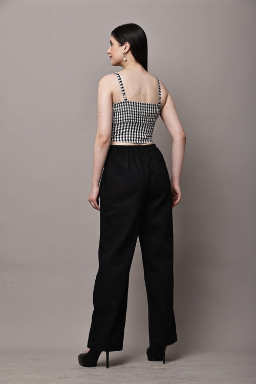 Back view of black and white gingham co-ord set for women with bustier crop top and high waist wide leg trousers