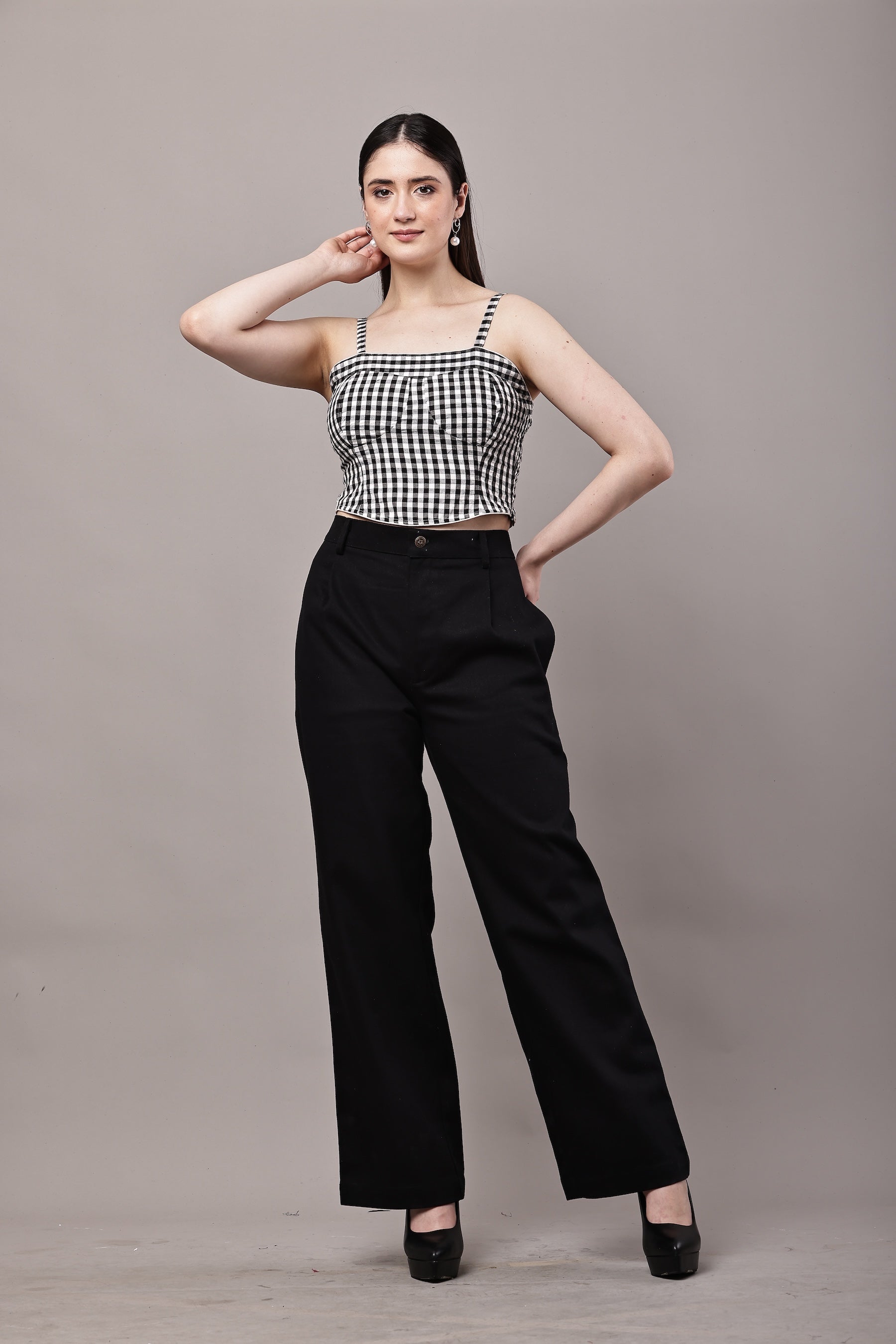 Front view of black and white gingham co-ord set for women with bustier crop top and high waist wide leg trousers