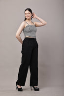 Side view of black and white gingham co-ord set for women with bustier crop top and high waist wide leg trousers