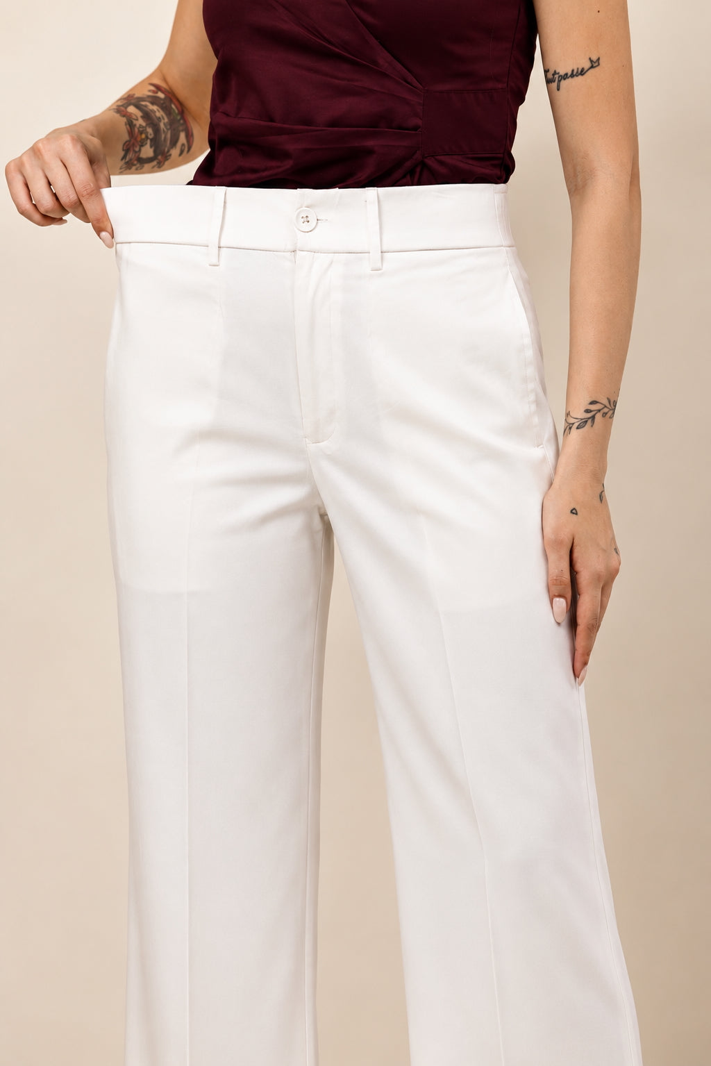 Ameera ivory white high-rise parallel cotton satin trousers for women styled with a burgundy top
